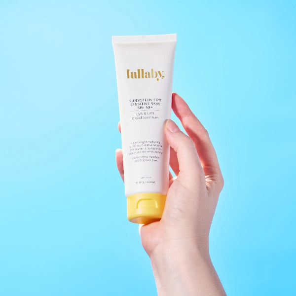 Hand holding Lullaby SPF50+ sensitive skin sunscreen — SPF50 broad spectrum protection